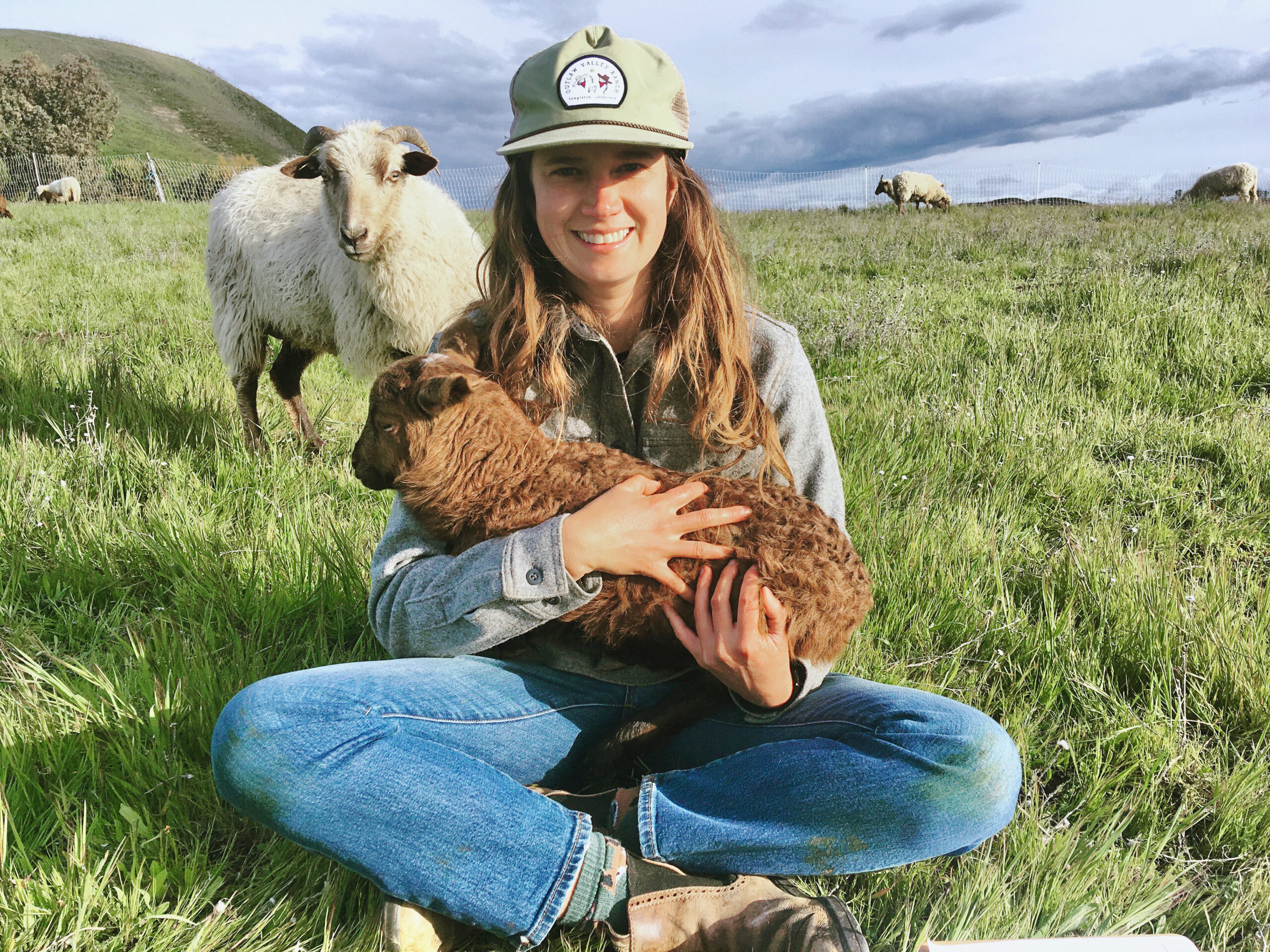 Kelsey Karol woman rancher with lamb